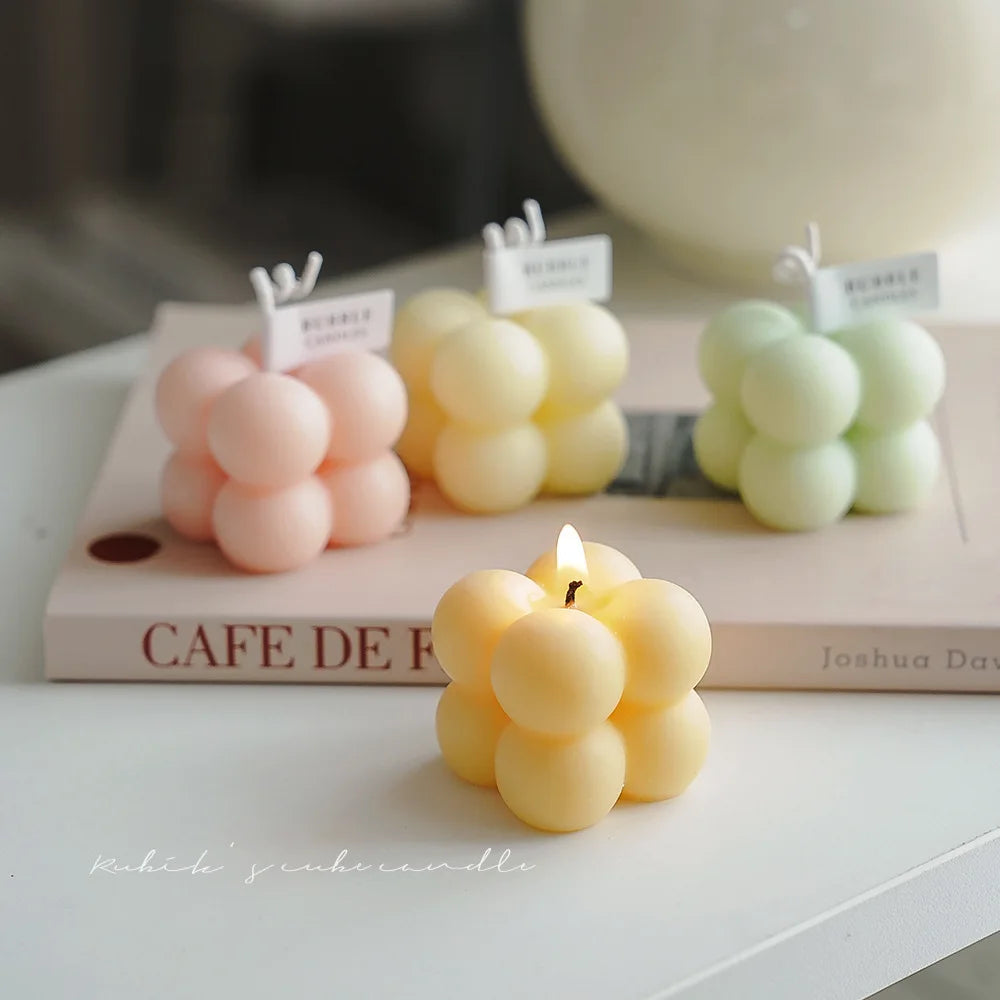 A square ball-shaped scented candle, a colorful birthday gift, a handcrafted candle, and a cute-shaped scented candle