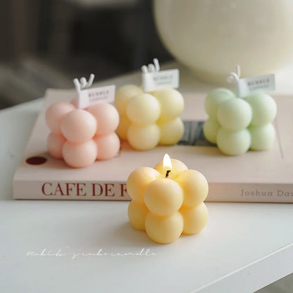 A square ball-shaped scented candle, a colorful birthday gift, a handcrafted candle, and a cute-shaped scented candle