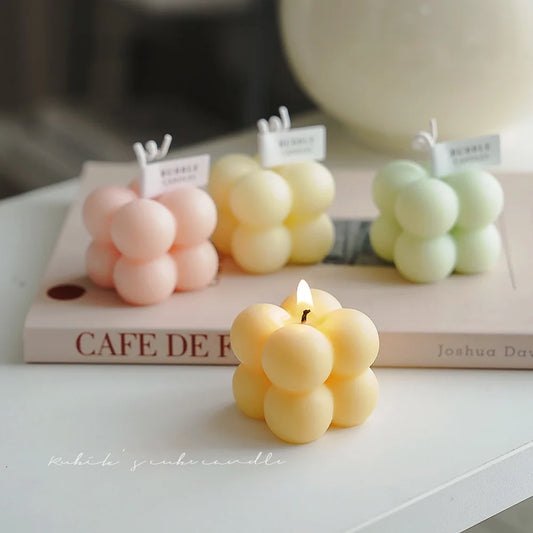 A square ball-shaped scented candle, a colorful birthday gift, a handcrafted candle, and a cute-shaped scented candle