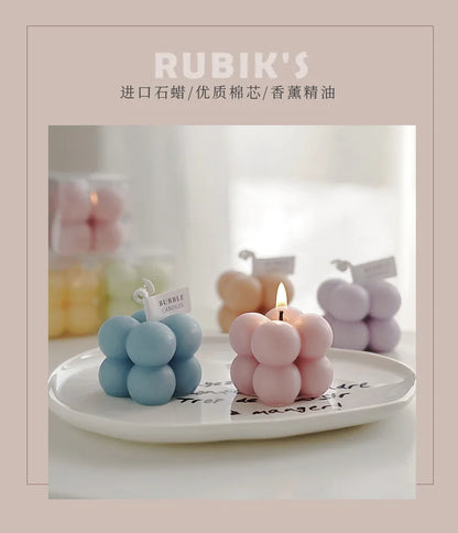 A square ball-shaped scented candle, a colorful birthday gift, a handcrafted candle, and a cute-shaped scented candle