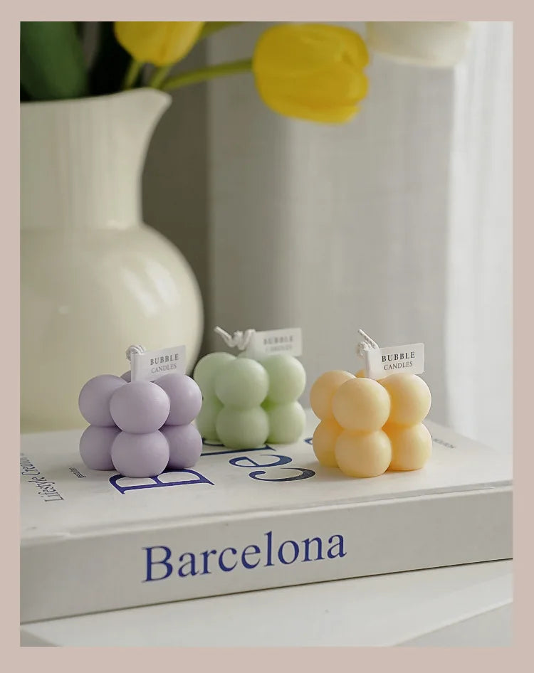 A square ball-shaped scented candle, a colorful birthday gift, a handcrafted candle, and a cute-shaped scented candle